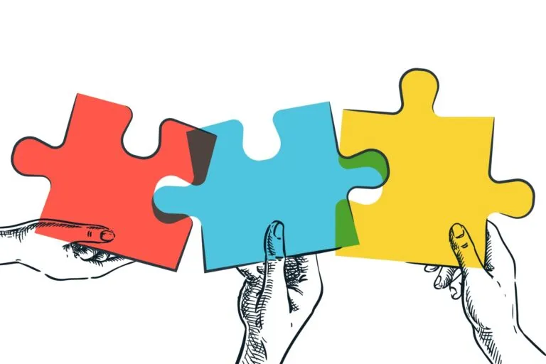Ilustración de tres manos sosteniendo piezas de rompecabezas en colores rojo, azul y amarillo, símbolo de creatividad y comunidad en la Fiesta de rompecabezas.